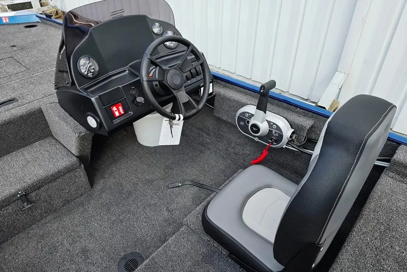 Slide: The Image of 2026 Lowe Skorpion 16 boat interior with steering wheel and control panel. - 3