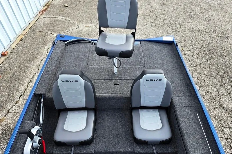 Slide: The Image of 2026 Lowe Skorpion 16 boat interior with three gray seats on a carpeted deck. - 8