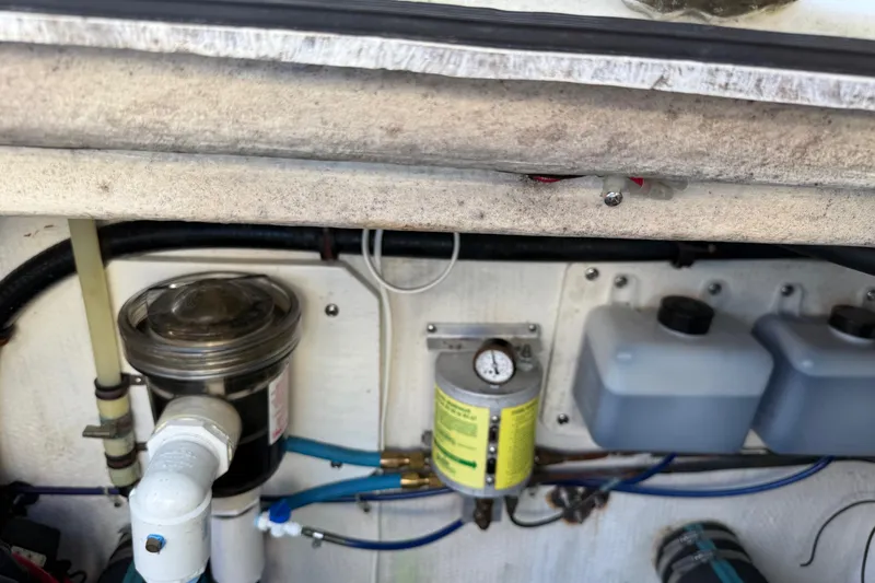 Slide: The Image of Engine compartment of a 1996 Harbor Master 52 Wide Body boat, showing various components. - 16