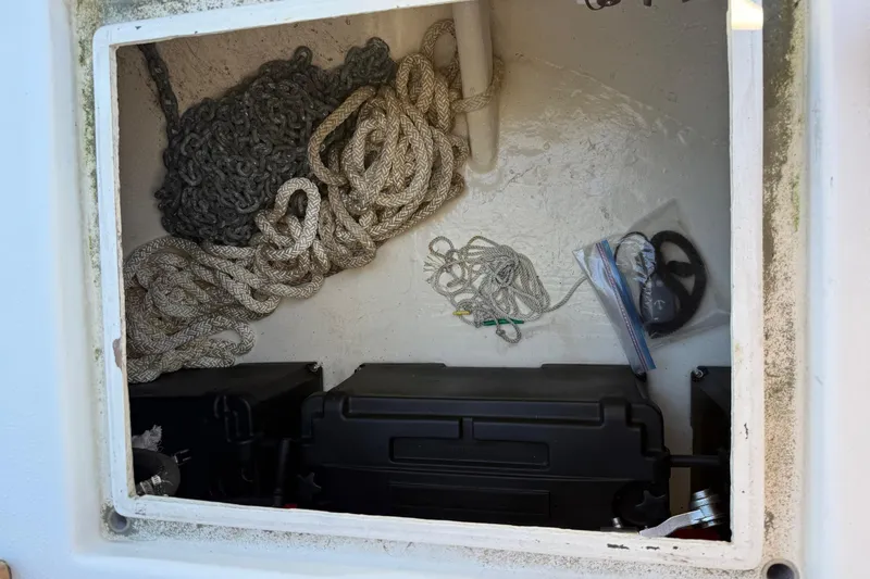 Slide: The Image of Storage compartment of 1996 Harbor Master 52 Wide Body with ropes and equipment. - 20