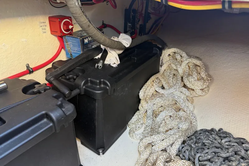 Slide: The Image of Battery compartment with cables and ropes on a 1996 Harbor Master 52 Wide Body boat. - 21