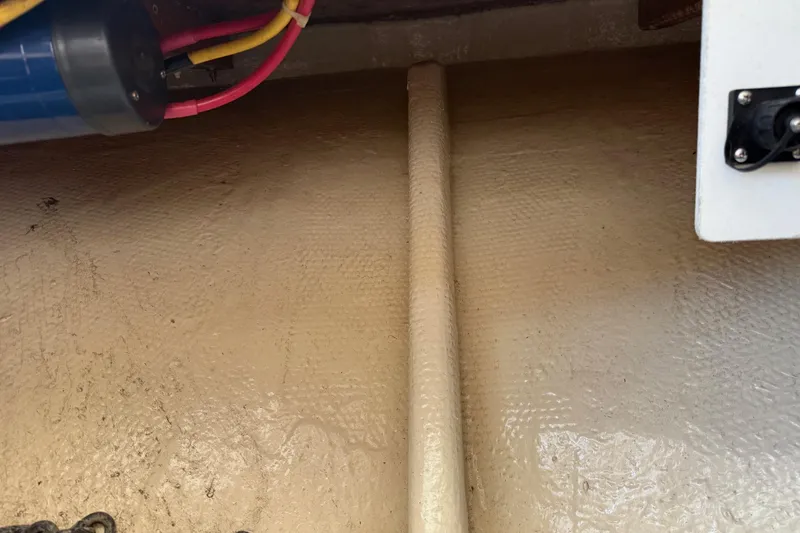 Slide: The Image of 1996 Harbor Master 52 Wide Body boat interior with wiring and textured surface. - 23