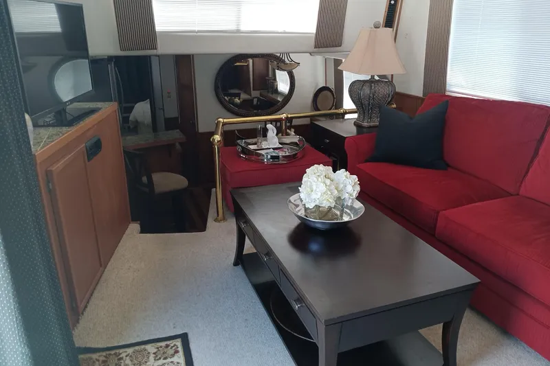 Slide: The Image of Interior of 1996 Harbor Master 52 Wide Body with red sofa and elegant decor. - 25