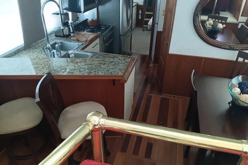 Slide: The Image of Interior of a 1996 Harbor Master 52 Wide Body yacht with kitchen and dining area. - 26