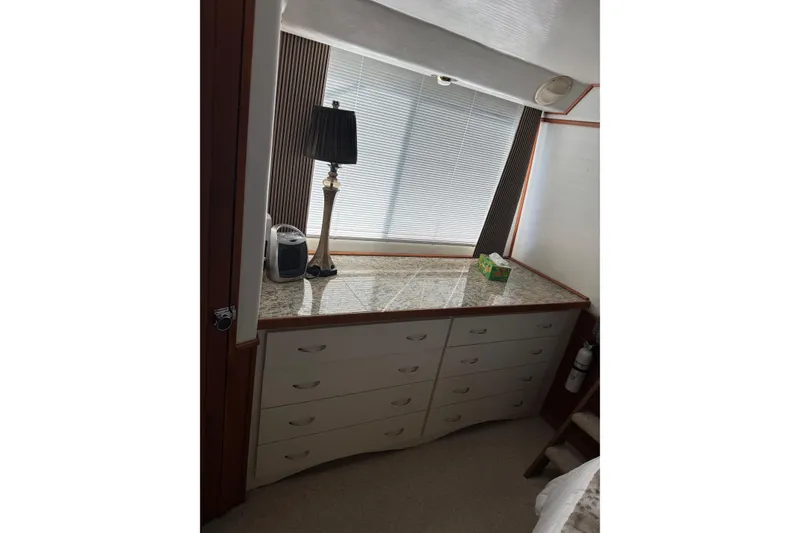 Slide: The Image of Interior of 1996 Harbor Master 52 Wide Body with dresser, lamp, and window blinds. - 27