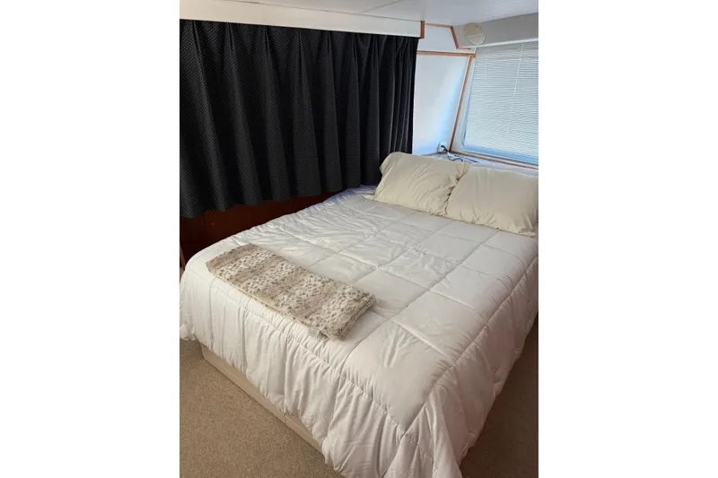 Slide: The Image of Cozy bedroom in 1996 Harbor Master 52 Wide Body yacht with white bedding. - 29