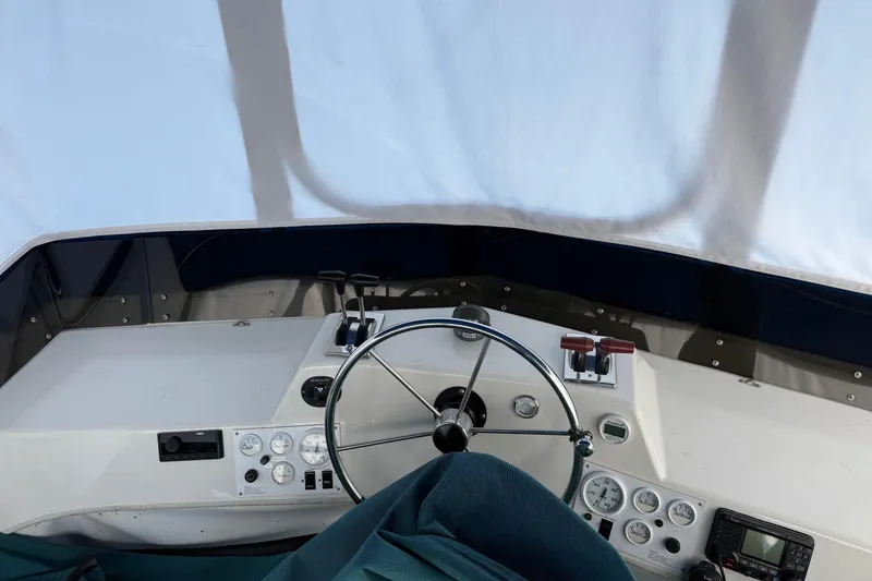 Slide: The Image of Interior helm of 1996 Harbor Master 52 Wide Body boat with steering wheel and controls. - 3