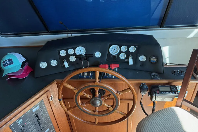 Slide: The Image of Helm of 1996 Harbor Master 52 Wide Body with wooden wheel and control panel. - 30