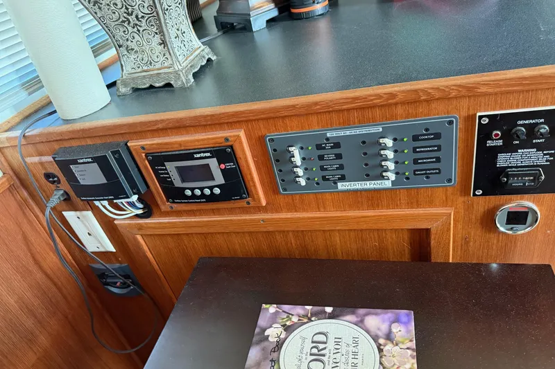 Slide: The Image of Control panel of a 1996 Harbor Master 52 Wide Body boat with inverter and generator switches. - 33