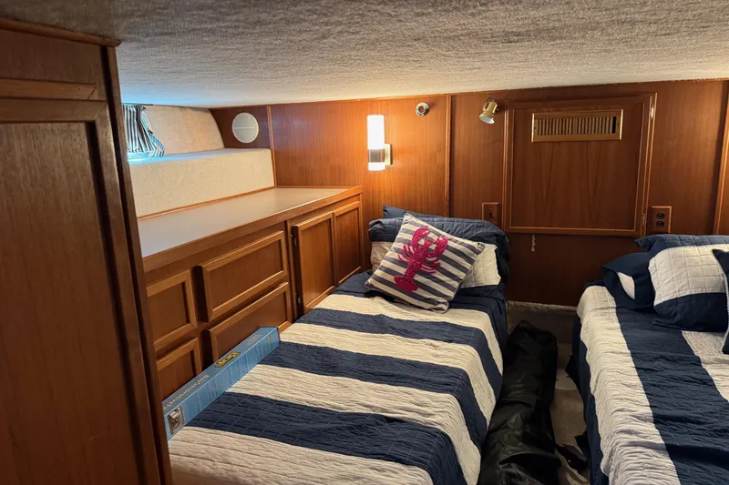 Slide: The Image of Cozy cabin interior of 1996 Harbor Master 52 Wide Body with twin beds and nautical decor. - 34