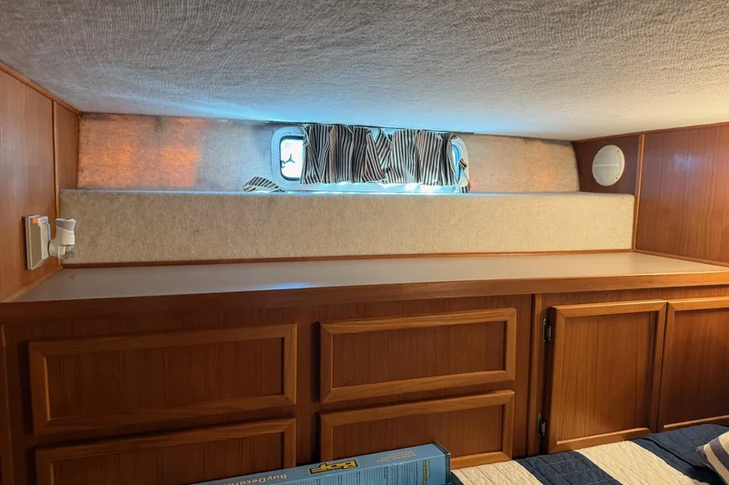 Slide: The Image of Interior of 1996 Harbor Master 52 Wide Body with wood cabinetry and small window. - 36