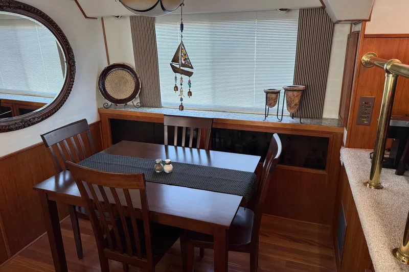 Slide: The Image of Dining area in a 1996 Harbor Master 52 Wide Body yacht with wooden table and decor. - 41