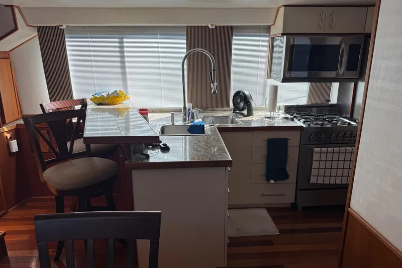 Slide: The Image of Kitchen interior of a 1996 Harbor Master 52 Wide Body yacht with modern appliances. - 42