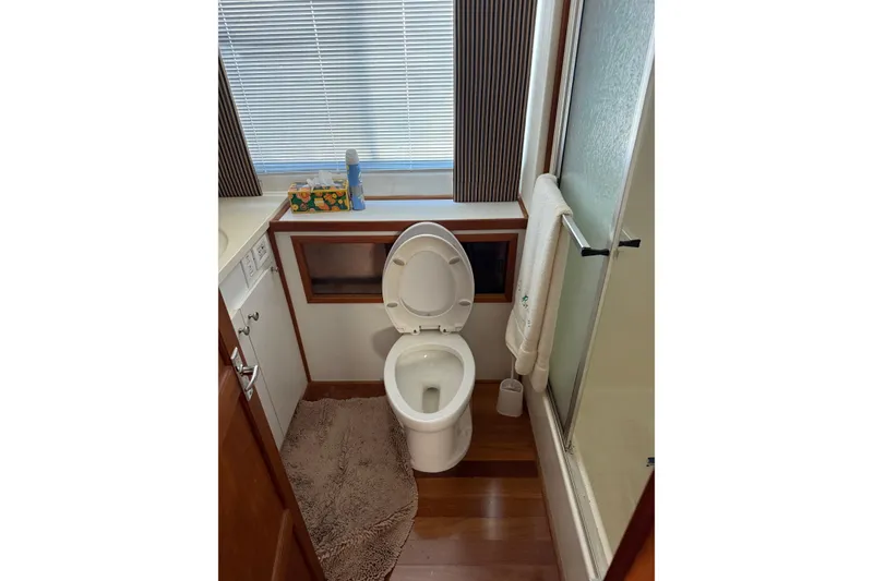 Slide: The Image of Bathroom interior of 1996 Harbor Master 52 Wide Body yacht, featuring toilet and shower. - 45