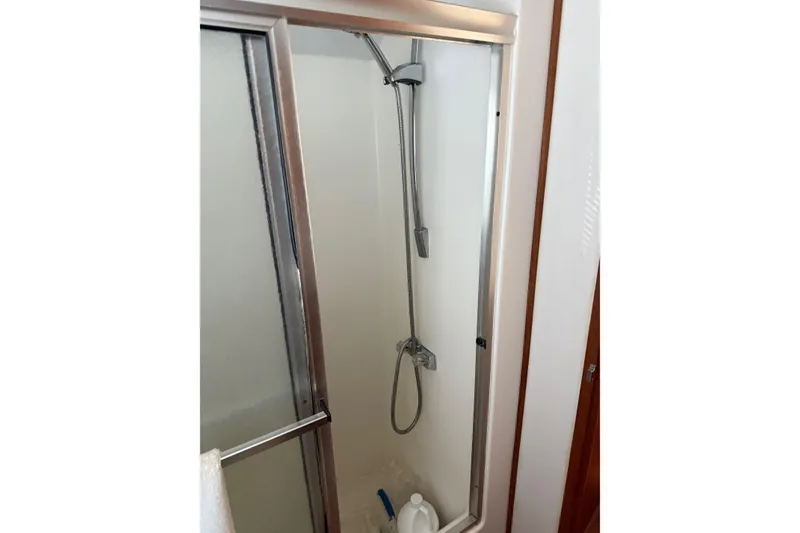 Slide: The Image of Shower area in 1996 Harbor Master 52 Wide Body boat with sliding glass door. - 46
