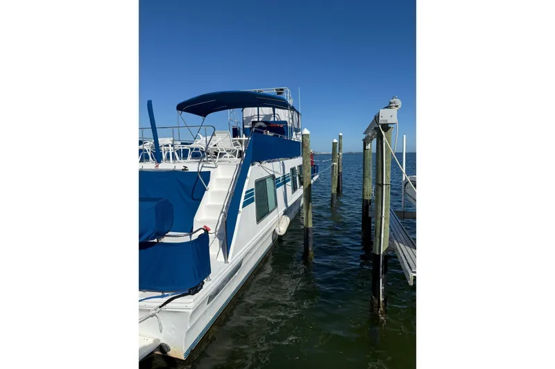 Slide: The Image of 1996 Harbor Master 52 Wide Body yacht docked on a sunny day. - 9