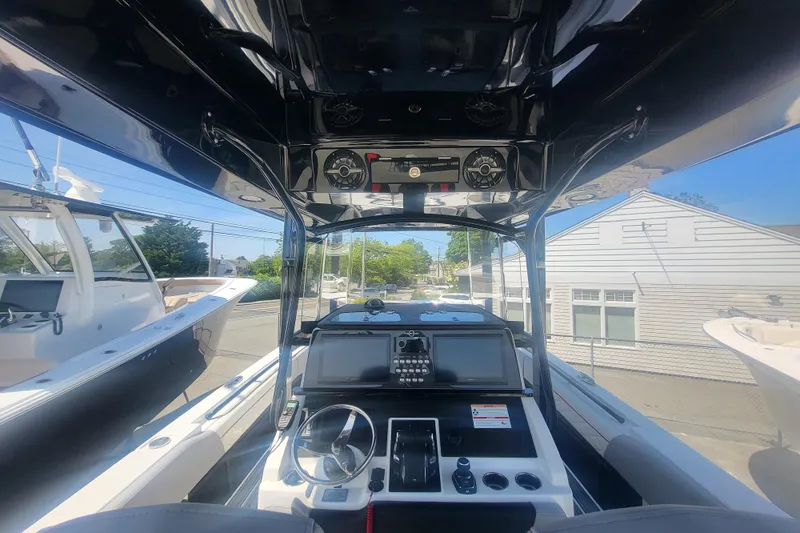 Slide: The Image of Interior view of 2025 Fountain 34 SC boat cockpit with modern controls and steering wheel. - 14