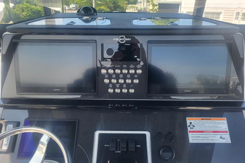 Slide: The Image of Dashboard of 2025 Fountain 34 SC boat with dual Garmin displays and control panel. - 16