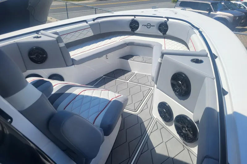 Slide: The Image of 2025 Fountain 34 SC boat interior with luxurious seating and high-quality speakers. - 19