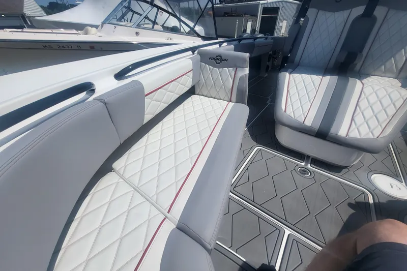 Slide: The Image of 2025 Fountain 34 SC boat interior with quilted seating and modern design. - 24