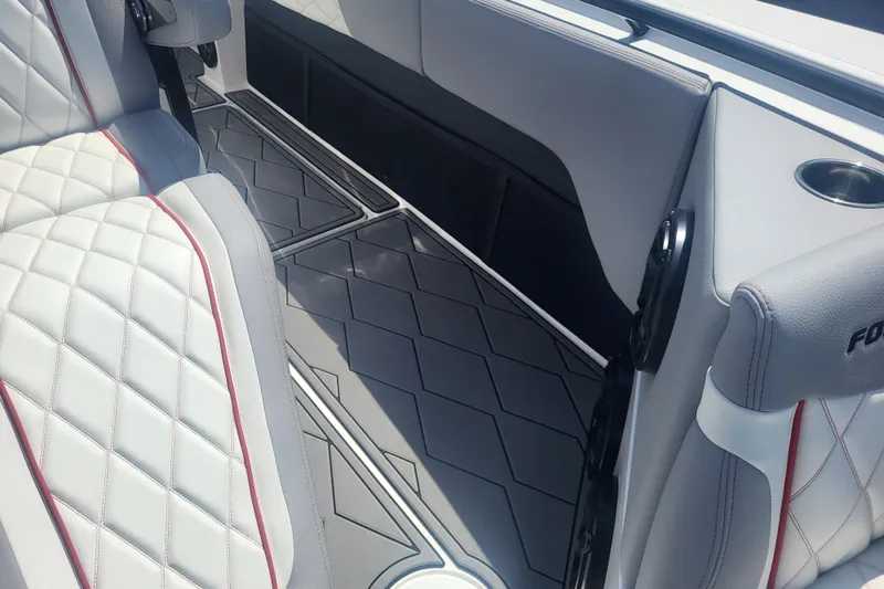 Slide: The Image of 2025 Fountain 34 SC boat interior with quilted seats and modern flooring. - 28
