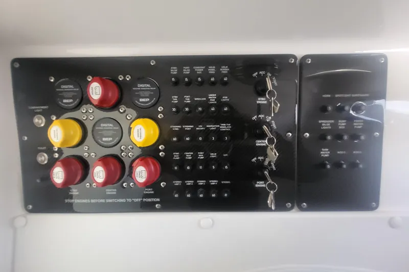 Slide: The Image of Control panel of a 2025 Fountain 34 SC boat with switches and dials. - 39