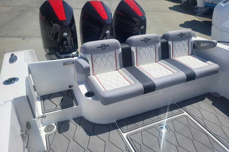 Slide: The Image of 2025 Fountain 34 SC boat interior with triple engines and cushioned seating. - 7