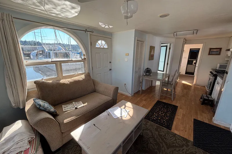 Slide: The Image of Interior of a 2004 River Floating Home with cozy living area and waterfront view. - 3