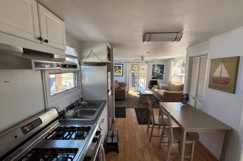 Slide: The Image of Interior of a 2004 River Floating Home with kitchen and cozy living area. - 7