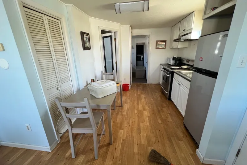Slide: The Image of Compact kitchen and dining area in a 2004 River Floating Home with wooden flooring. - 8