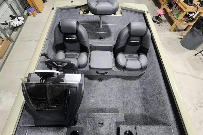 Slide: The Image of 2026 Tracker Pro Team 175 boat interior with gray seating and steering console. - 4