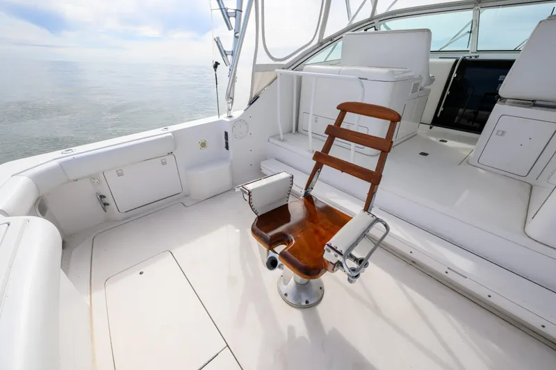 Slide: The Image of 1998 Bertram 36 Moppie boat interior with fishing chair and white seating. - 10
