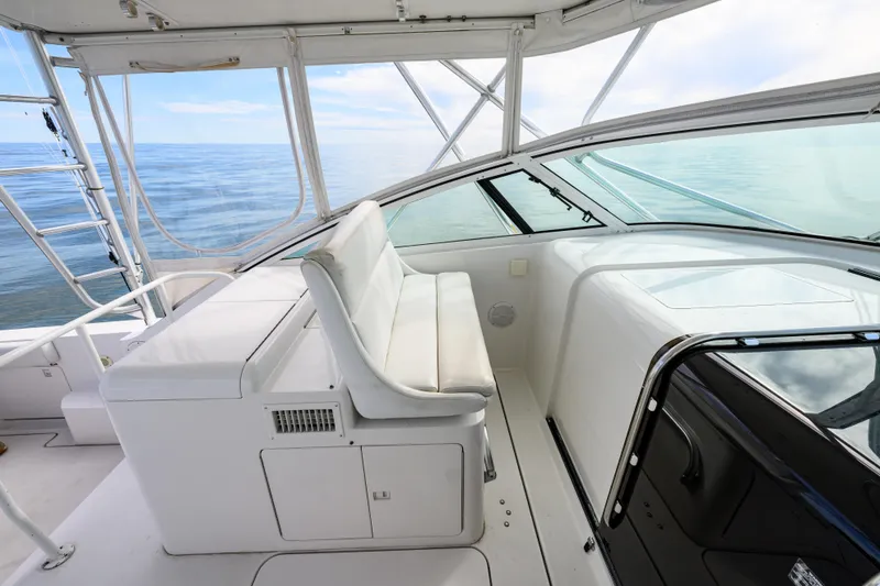 Slide: The Image of 1998 Bertram 36 Moppie boat interior with white seating and ocean view. - 14