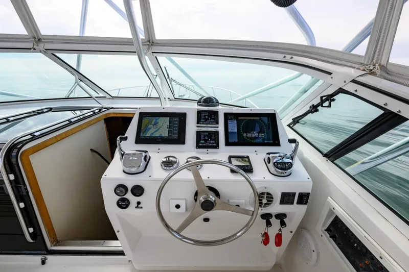 Slide: The Image of Cockpit of 1998 Bertram 36 Moppie yacht with navigation equipment and steering wheel. - 15