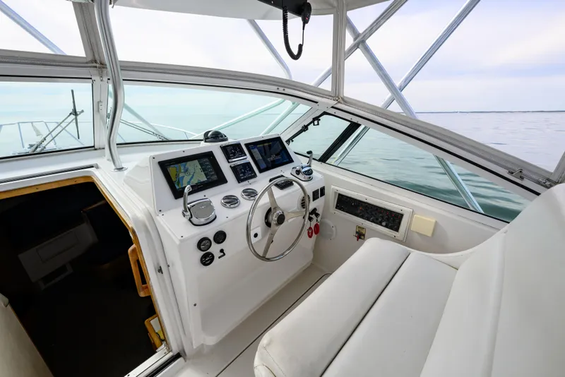 Slide: The Image of Cockpit of a 1998 Bertram 36 Moppie boat with navigation equipment and steering wheel. - 17