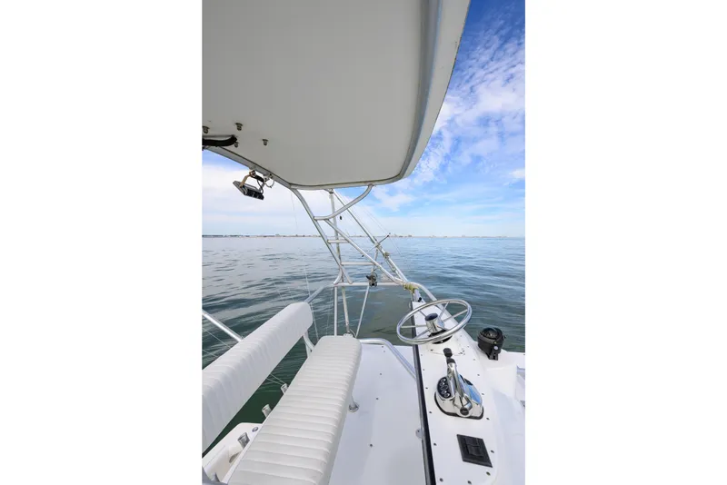 Slide: The Image of 1998 Bertram 36 Moppie boat helm with ocean view and clear sky. - 21