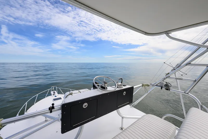 Slide: The Image of 1998 Bertram 36 Moppie boat helm with ocean view under blue sky. - 23