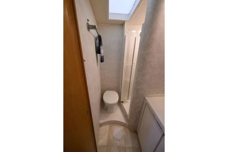 Slide: The Image of Bathroom interior of 1998 Bertram 36 Moppie yacht, featuring toilet and shower. - 25