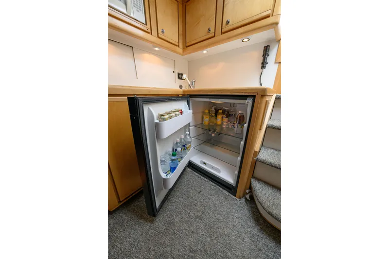 Slide: The Image of Open fridge in 1998 Bertram 36 Moppie yacht interior, stocked with beverages. - 28