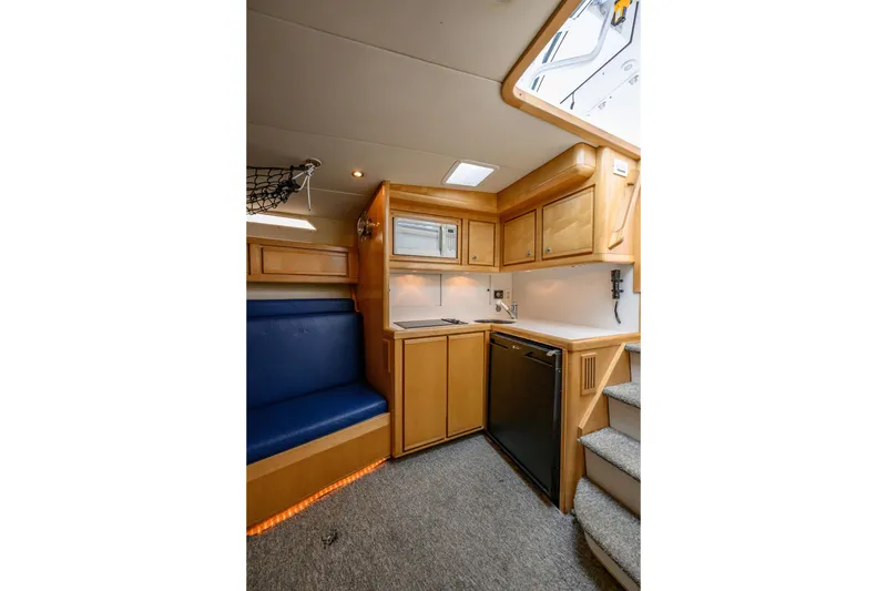 Slide: The Image of Interior of 1998 Bertram 36 Moppie yacht with kitchenette and seating area. - 29
