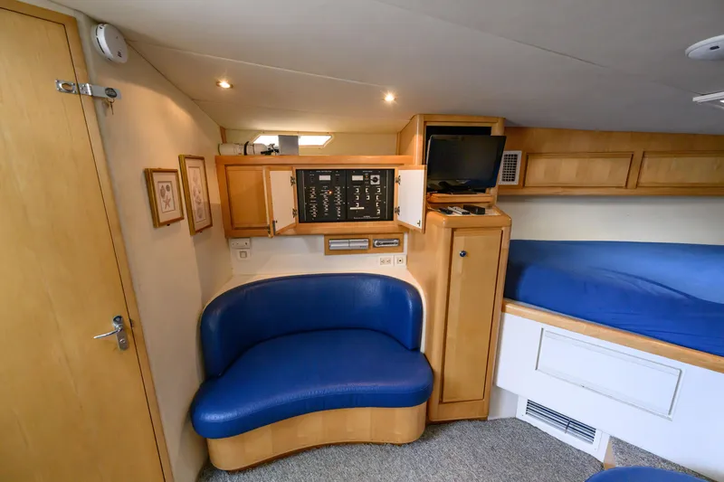 Slide: The Image of Interior of 1998 Bertram 36 Moppie yacht with blue seating and control panel. - 32