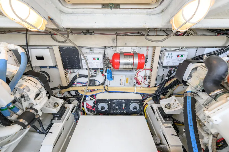Slide: The Image of Engine room of 1998 Bertram 36 Moppie boat, showcasing wiring and equipment. - 34