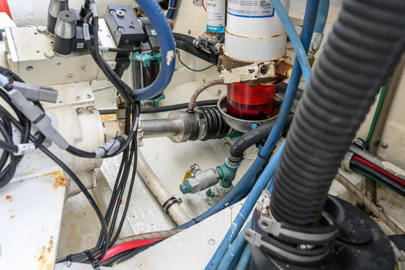 Slide: The Image of Engine room of a 1998 Bertram 36 Moppie with visible mechanical components and wiring. - 35