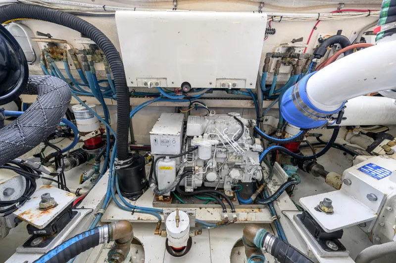 Slide: The Image of Engine room of a 1998 Bertram 36 Moppie boat, showcasing mechanical components. - 37