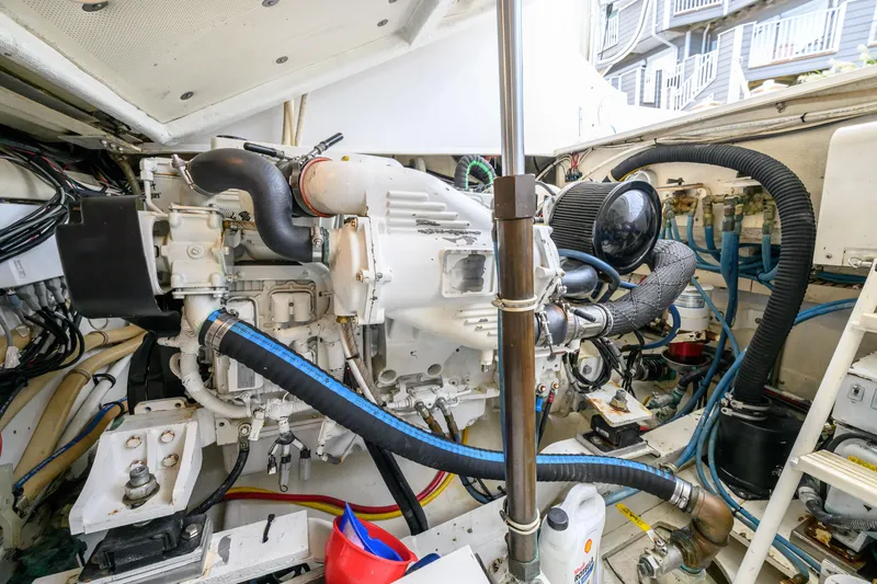 Slide: The Image of Engine room of a 1998 Bertram 36 Moppie boat, showcasing detailed machinery and components. - 38