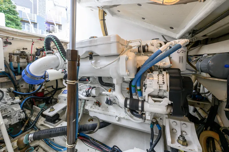 Slide: The Image of Engine room of a 1998 Bertram 36 Moppie boat, showcasing detailed machinery. - 39