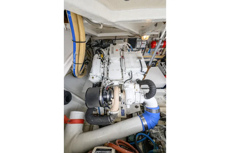 Slide: The Image of Engine room of a 1998 Bertram 36 Moppie boat, showcasing mechanical components. - 40