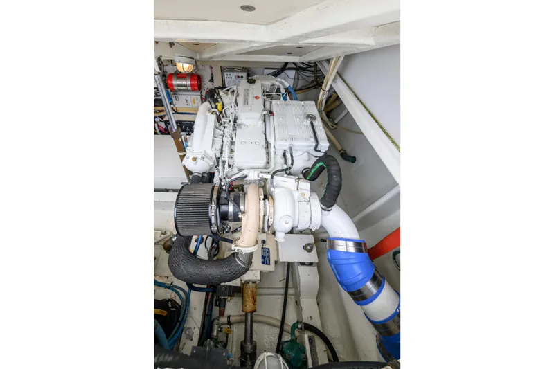Slide: The Image of Engine compartment of a 1998 Bertram 36 Moppie boat, showcasing detailed mechanical components. - 41