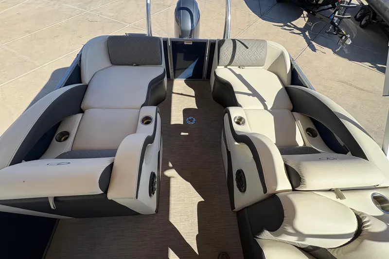 Slide: The Image of 2017 Veranda Relax V2275RFL boat interior with plush seating and cup holders. - 11