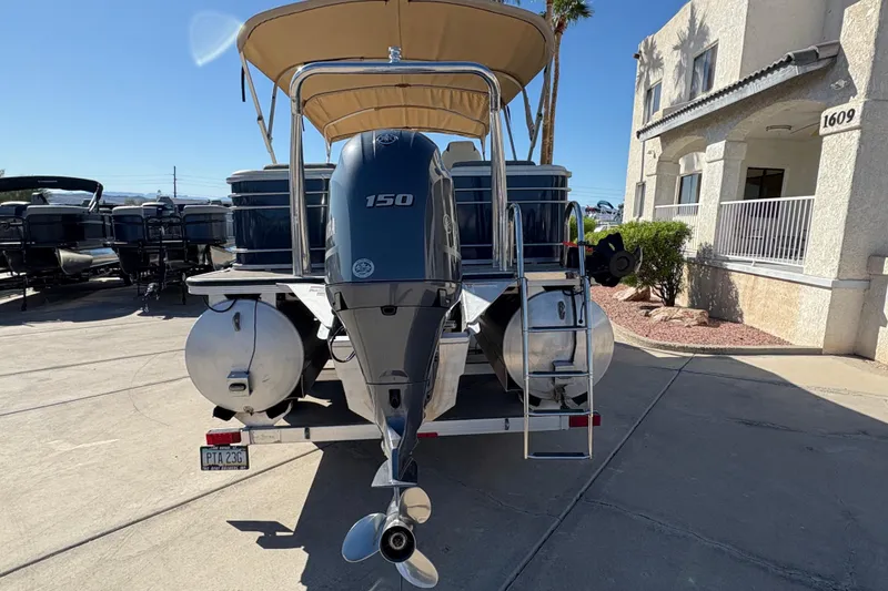 Slide: The Image of 2017 Veranda Relax V2275RFL pontoon boat with 150 HP engine, parked outdoors. - 4